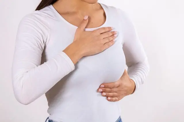 Woman hand checking lumps her breast signs breast cancer gray background healthcare concept closeup woman s hand breast showing cancer symptom 657921 1209