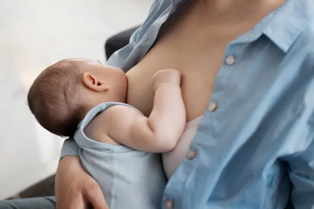 Mom gently breast feeding her child 1