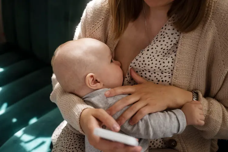 High angle woman breastfeeding baby indoors 1