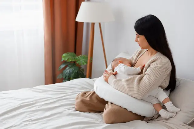 Full shot mother holding newborn baby 2 scaled